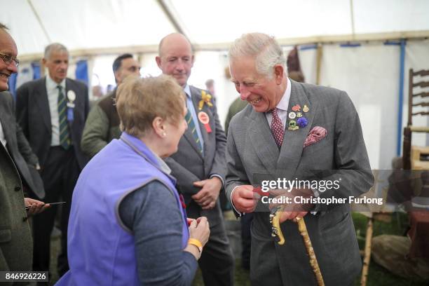 Prince Charles, Prince of Wales, is presented with a crochet poppy as he attends The Westmorland County Show on September 14, 2017 in Milnthorpe,...