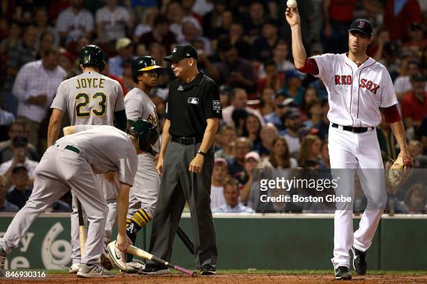 Boston Red Sox starting pitcher Doug Fister asks for a new ball after Oakland Athletics right fielder Matt Joyce scored during the third inning. The...