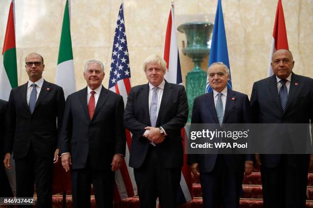 In his capacity as host, Britain's Foreign Secretary Boris Johnson, center, poses for a group photograph with, from left, Italy's Foreign Minister...