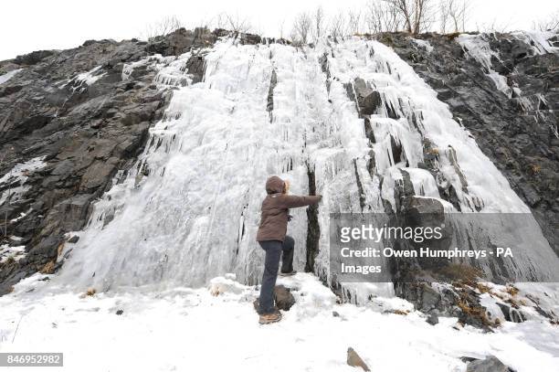 Walker Mark Proud from Weardale looks at the icicles at Tebay in Cumbria.