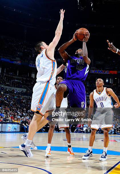 John Salmons of the Sacramento Kings goes to the basket against Nick Collison of the Oklahoma City Thunder at the Ford Center on February 8, 2009 in...