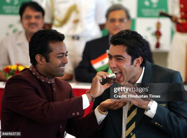 Leander Paes feeds cake to Aisam Ul Haq Qureshi of the Pakistan tennis team to celebrate the birth of his baby girl. The Davis Cup draw ceremony was...