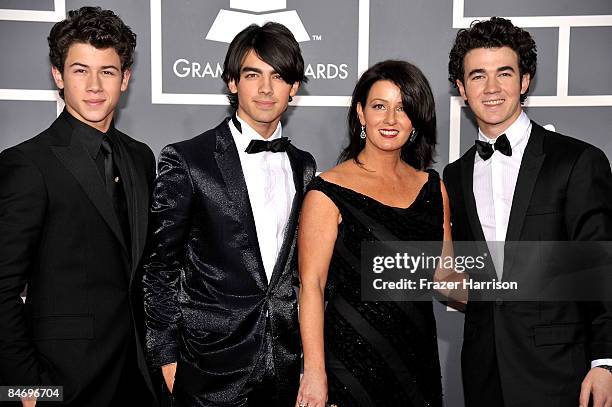 Musicians Nick Jonas, Joe Jonas and Kevin Jonas of The Jonas Brothers with mother mother Denise Jonas arrive at the 51st Annual Grammy Awards held at...