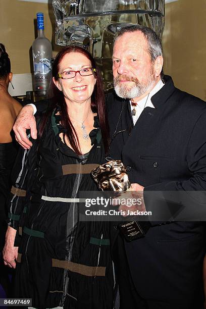 Terry Gilliam and wife Maggie Weston pose with his Academy Fellowship Award attends the Soho House Grey Goose After Party at the Grosvenor House...