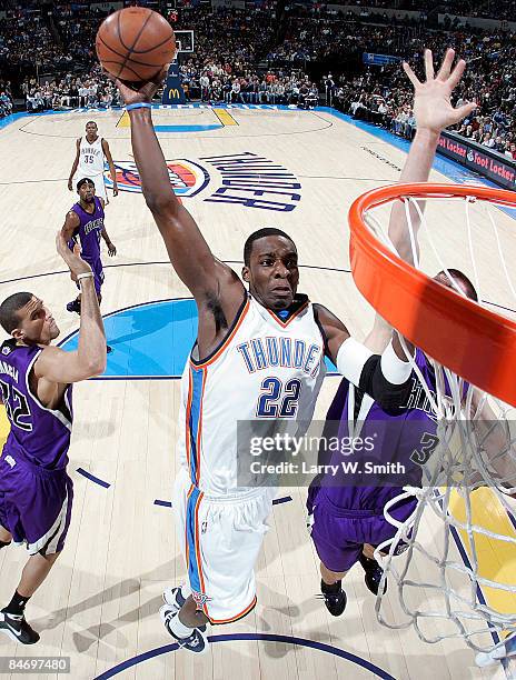 Jeff Green of the Oklahoma City Thunder goes up for a slam dunk against Spencer Hawes the Sacramento Kings at the Ford Center on February 8, 2009 in...