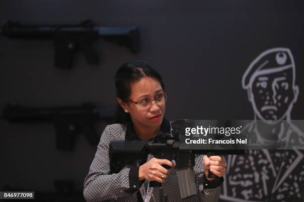Visitor inspects the rifle selection during The International Hunting and Equestrian Exhibition at Abu Dhabi National Exhibition Centre on September...