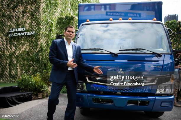 Marc Llistosella, chief executive officer of Mitsubishi Fuso Truck and Bus Corp., speaks while standing next to the eCanter truck during a launch...