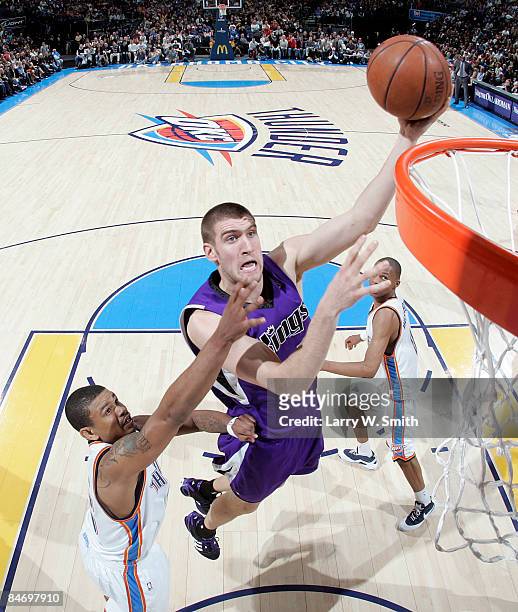 Spencer Hawes of the Sacramento Kings goes to the basket against Earl Watson of the Oklahoma City Thunder at the Ford Center on February 8, 2009 in...