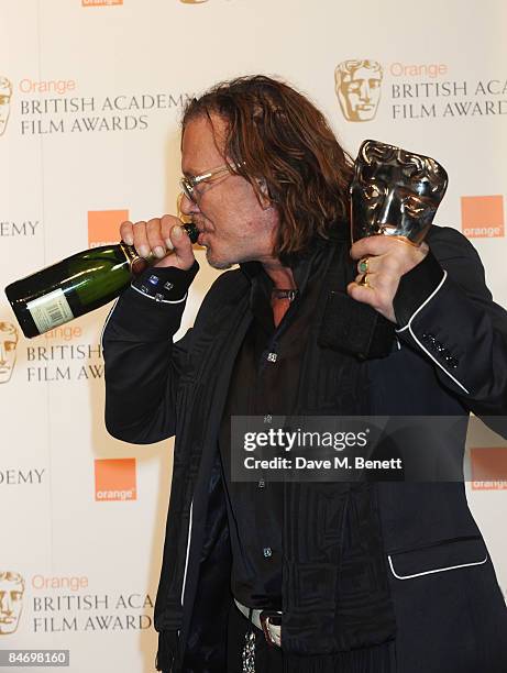 Mickey Rourke poses in the press room with the Best Actor Award for The Wrestler during the The Orange British Academy Film Awards 2009, at the Royal...