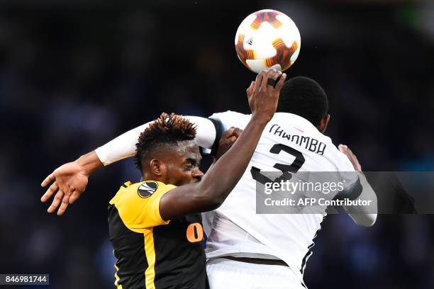 Young Boys' Kasim Nuhu fights for the ball with Partizan's Leandre Tawamba during the UEFA Europa League Group B football match between BSC Young...