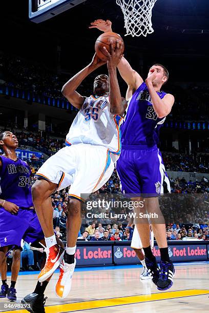 Kevin Durant of the Oklahoma City Thunder goes to the basket against Spencer Hawes of the Sacramento Kings at the Ford Center on February 8, 2009 in...