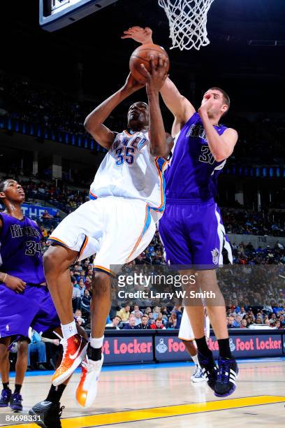 Kevin Durant of the Oklahoma City Thunder goes to the basket against Spencer Hawes of the Sacramento Kings at the Ford Center on February 8, 2009 in...