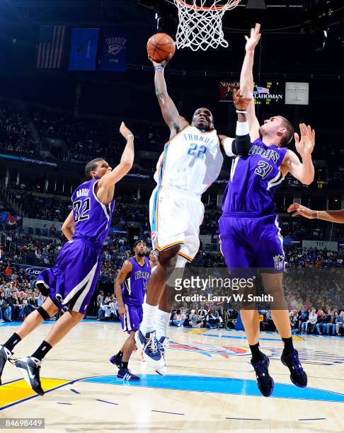 Jeff Green of the Oklahoma City Thunder goes up for a slam dunk against Spencer Hawes the Sacramento Kings at the Ford Center on February 8, 2009 in...