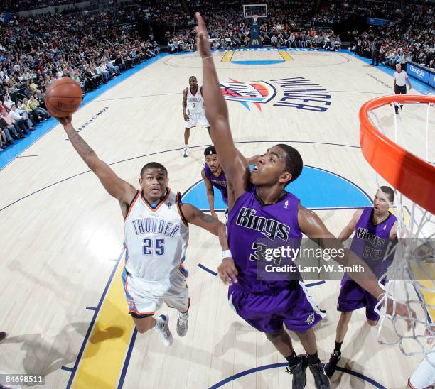 Earl Watson of the Oklahoma City Thunder goes to the basket against Jason Thompson of the Sacramento Kings at the Ford Center on February 8, 2009 in...