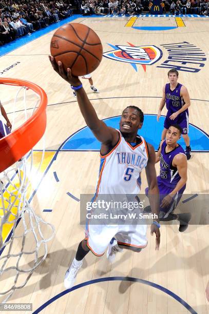 Kyle Weaver of the Oklahoma City Thunder goes to the basket against Kevin Martin of the Sacramento Kings at the Ford Center on February 8, 2009 in...