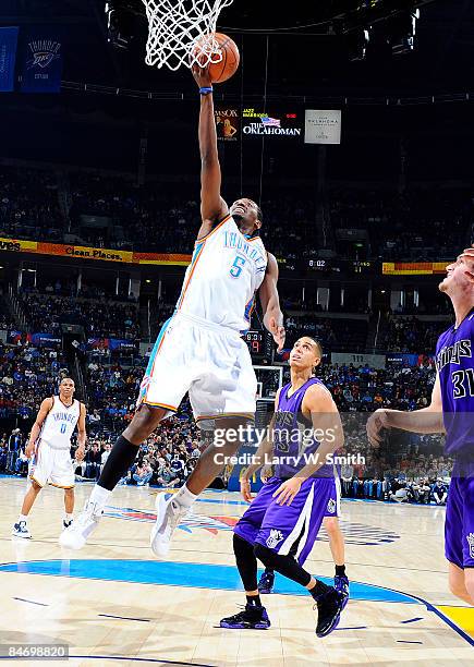 Kyle Weaver of the Oklahoma City Thunder goes to the basket against Kevin Martin of the Sacramento Kings at the Ford Center on February 8, 2009 in...