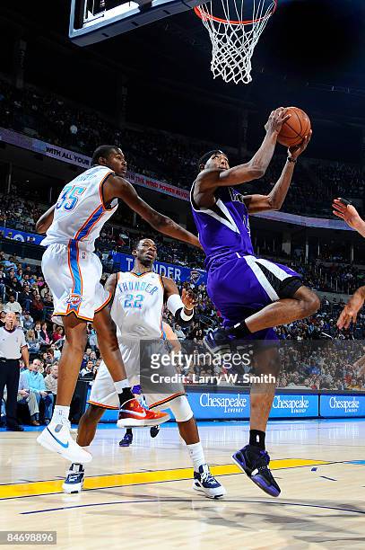 John Salmons of the Sacramento Kings goes to the basket against Kevin Durant of the Oklahoma City Thunder at the Ford Center on February 8, 2009 in...