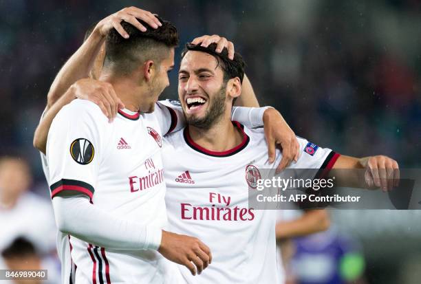 Milan's forward from Portugal Andre Silva celebrates scoring with midfielder from Turkey Hakan Calhanoglu during the UEFA Europa League group D...