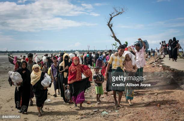 Rohingya are seen after arriving on a boat to Bangladesh on September 14, 2017 in Shah Porir Dip, Bangladesh. Around 370,000 Rohingya refugees have...