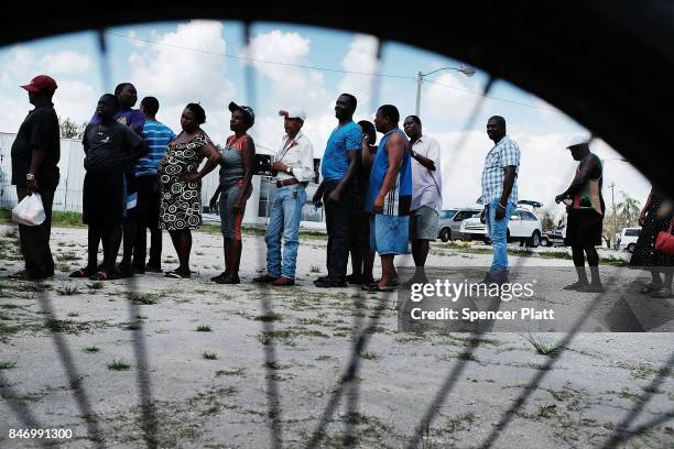 Residents of a rural migrant-worker town wait for emergency donations following Hurricane Irma on September 14, 2017 in Immokalee, Florida. A group...