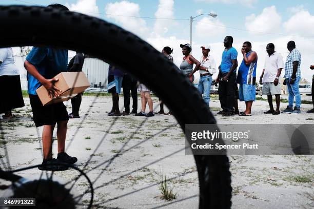 Residents of a rural migrant-worker town wait for emergency donations following Hurricane Irma on September 14, 2017 in Immokalee, Florida. A group...