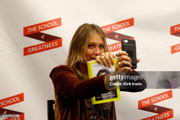 Maria Sharapova finishes up time lapse that she created while signing copies of her book during the Summit of Greatness on September 14, 2017 in...