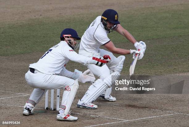 Matthew Lamb of Warwickshire plays the balll past James Foster during the Specsavers County Championship Division One match between Warwickshire and...