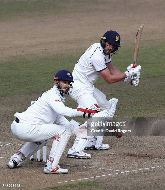 Matthew Lamb of Warwickshire plays the balll past James Foster during the Specsavers County Championship Division One match between Warwickshire and...