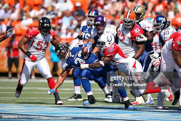 Running back Michael Turner of the NFC All-Stars Atlanta Falcons gets tackled by defensive end Robert Mathis of the AFC All-Stars Indianapolis Colts...