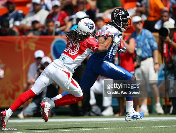 Wide receiver Roddy White of the NFC All-Stars Atlanta Falcons catches a pass and gets tackled by safety Michael Griffin of the AFC All-Stars...