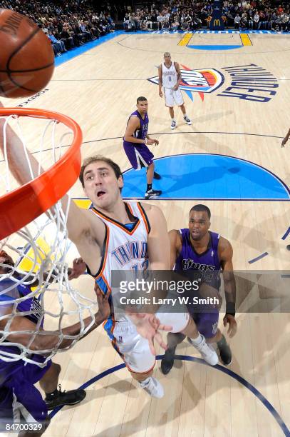 Nenad Krstic of the Oklahoma City Thunder goes to the basket against Shelden Williams of the Sacramento Kings at the Ford Center on February 8, 2009...