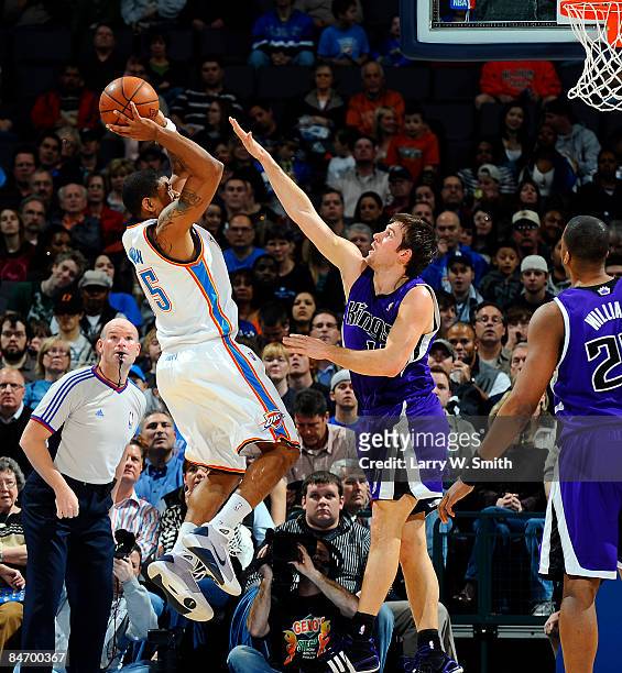 Earl Watson of the Oklahoma City Thunder goes to the basket against Beno Udrih of the Sacramento Kings at the Ford Center on February 8, 2009 in...