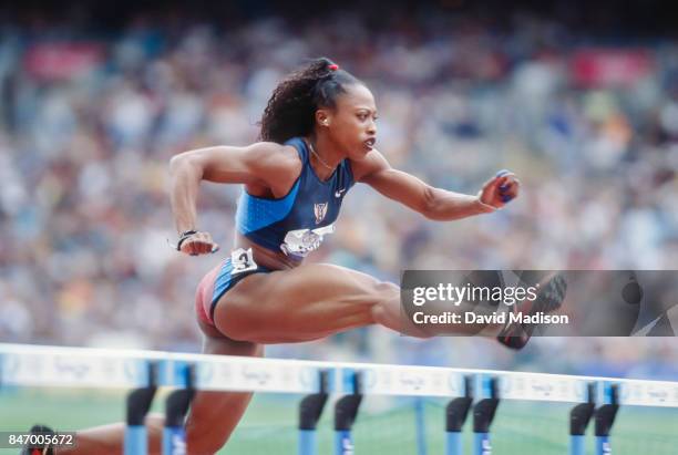 Gail Devers of the USA competes in the first round of the Women's 100 meter hurdles event of the 2000 Summer Olympics track and field competition on...