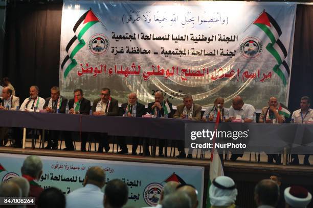 Palestinians, who sons was killed in 2007 during clashes between the rival Hamas and Fatah factions, signs a social reconciliation agreement during a...