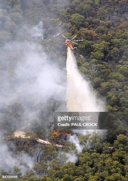 Fire-fighting aircraft dumps a load of water on the Bunyip Ridge wildfire, some 100 kms east of Melbourne on February 9, 2009. The wildfires, which...