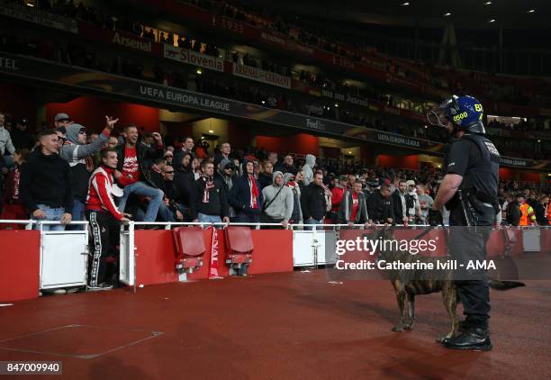 The FC Koln fans taunt the police dog and it's handler before the UEFA Europa League group H match between Arsenal FC and 1. FC Koeln at Emirates...