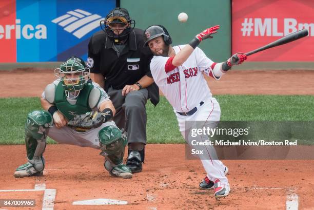 Dustin Pedroia of the Boston Red Sox hits a ground ball against the Oakland Athletics in the first inning at Fenway Park on September 14, 2017 in...