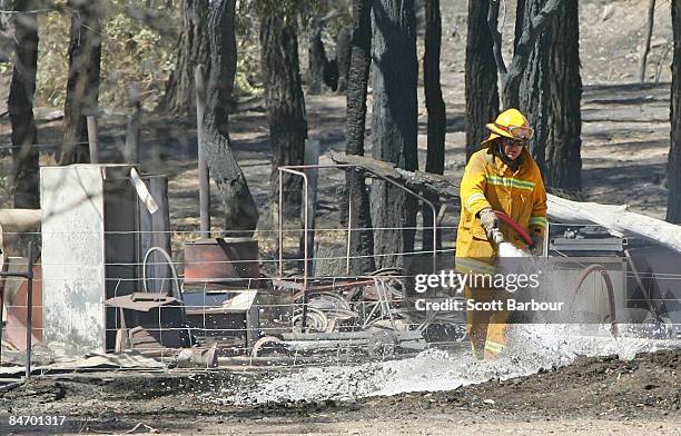 Fireman sprays foam on a burnt out property on February 9, 2009 in Bendigo, 160 km north of Melbourne, Australia. Eight bushfires are burning out of...