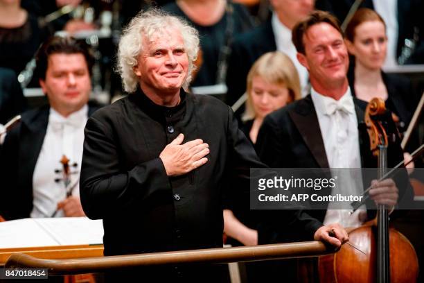 The London Symphony Orchestra's Music Director, Simon Rattle arrives to conduct the LSO, playing a programme by Helen Grime, Thomas Ades, Harrison...