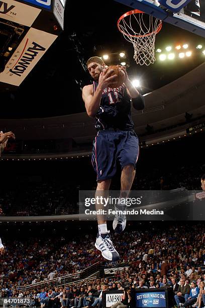 Brook Lopez of the New Jersey Nets pulls down a rebound against the Orlando Magic during the game on February 8, 2009 at Amway Arena in Orlando,...