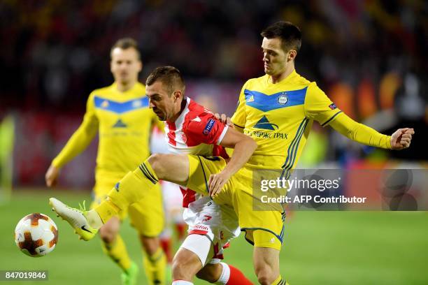 Crvena Zvezda's midfielder Nenad Krsticic vies with Bate's midfielder Mirko Ivanic during the UEFA Europa League match between FK Crvena Zvezda...