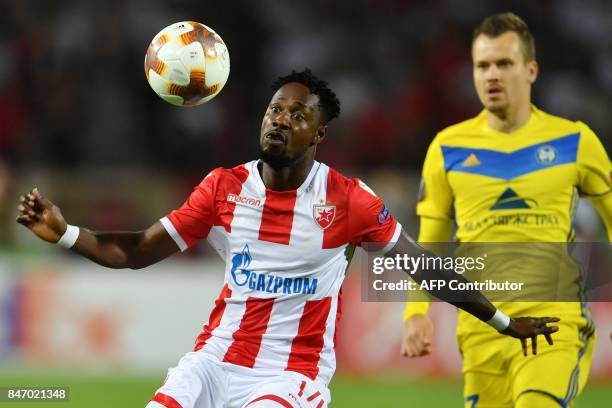 Crvena Zvezda's forward Richmond Boakye vies with Bate's defender Denis Polyakov during the UEFA Europa League match between FK Crvena Zvezda Beograd...