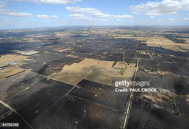 Scorched farmland shows the extent of the devastating wildfires which destroyed houses and farms and continues to burn in the Bunyip regions of...