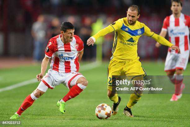 Crvena Zvezda's midfielder Slavoljub Srnic vies with Bate's midfielder Igor Stasevich during the UEFA Europa League match between FK Crvena Zvezda...