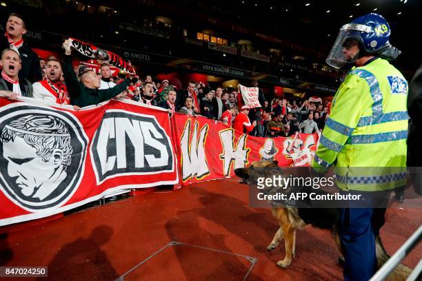 Police inside the stadium keep an eye on Cologne supporters in the stands as the kick off is delayed due to crowd safety issues ahead of the UEFA...