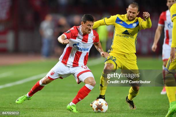 Crvena Zvezda's midfielder Slavoljub Srnic vies with Bate's midfielder Igor Stasevich during the UEFA Europa League match between FK Crvena Zvezda...