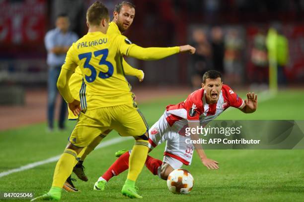 Crvena Zvezda's midfielder Slavoljub Srnic vies with Bate's defender Denis Polyakov during the UEFA Europa League match between FK Crvena Zvezda...