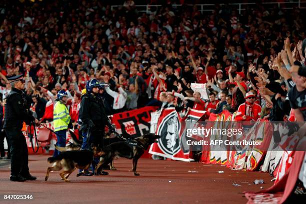 Police inside the stadium keep an eye on Cologne supporters in the stands as the kick off is delayed due to crowd safety issues ahead of the UEFA...