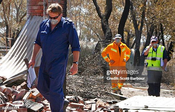 Police officers and CFA volunteers search through the remains of a burnt out property on February 9, 2009 in Bendigo, 160 km north of Melbourne,...