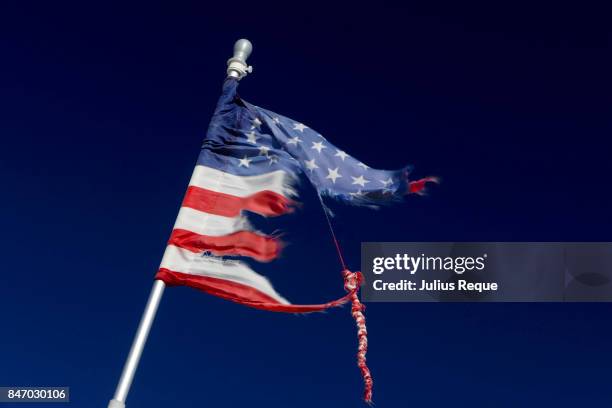 tattered us flag on a pole - war torn stock pictures, royalty-free photos & images